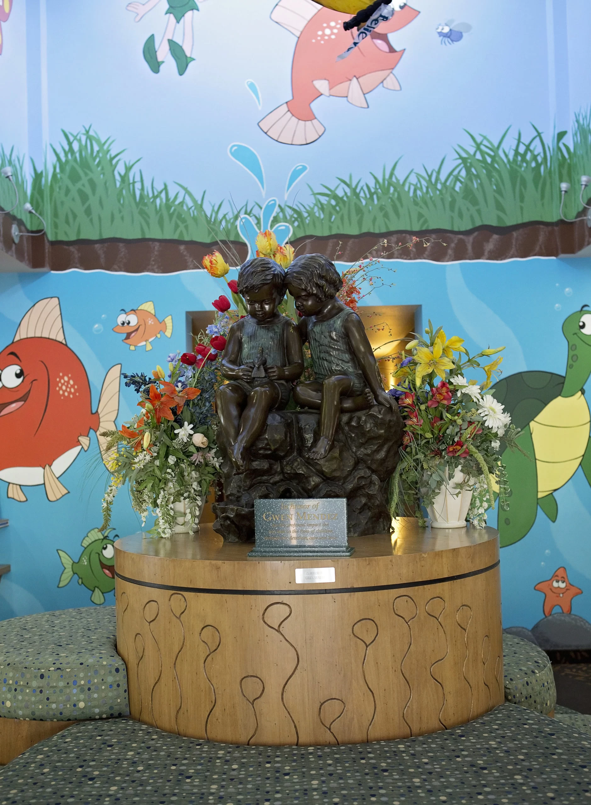 A statue of a boy and a girl representing home and community based services.