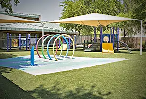 A pediatric therapy facility offering home and community-based services to children with cerebral palsy of Arizona, equipped with a slide and swings. A pediatric therapy facility offering home and community-based services to children with cerebral palsy of Arizona, equipped with a slide and swings.