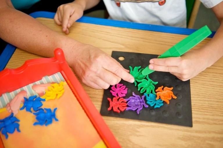 A child with cerebral palsy of Arizona is playing with a set of colorful shapes at a pediatric therapy and early learning center. A child with cerebral palsy of Arizona is playing with a set of colorful shapes at a pediatric therapy and early learning center.