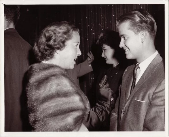 An old photo of a man talking to a woman at the pediatric therapy center. An old photo of a man talking to a woman at the pediatric therapy center.