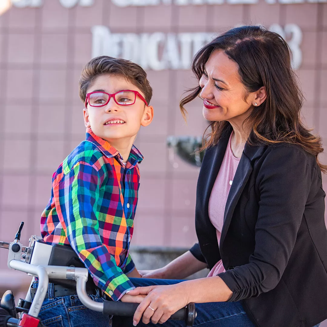 A boy with cerebral palsy receiving pediatric therapy at a home-based service in Arizona. Sebastian at UCP with Mother