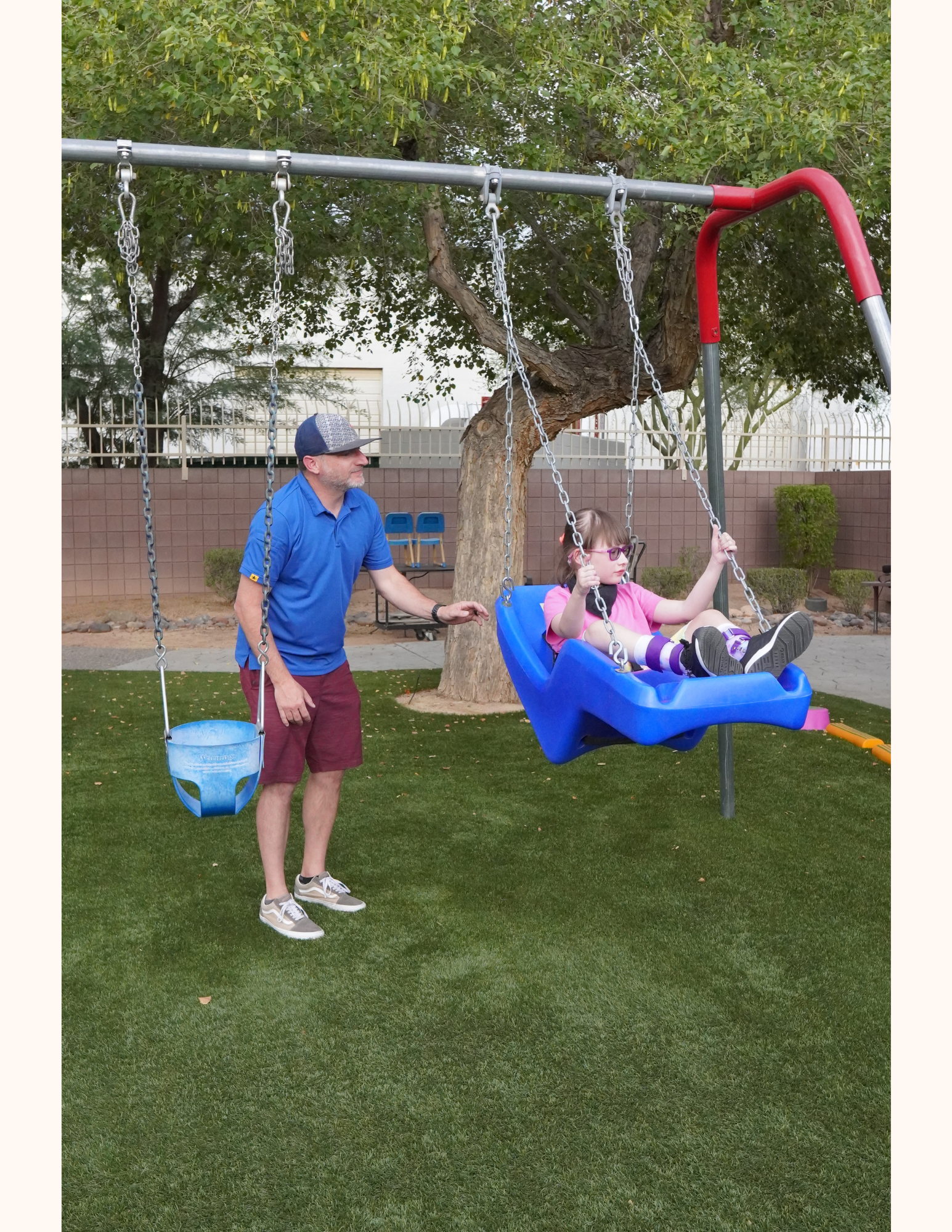 A man and girl on a swing enjoy quality time together, reflecting the supportive care offered by a habilitation provider in Phoenix, AZ.