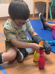 A young boy engaging in pediatric therapy at an early learning center. A young boy engaging in pediatric therapy at an early learning center.