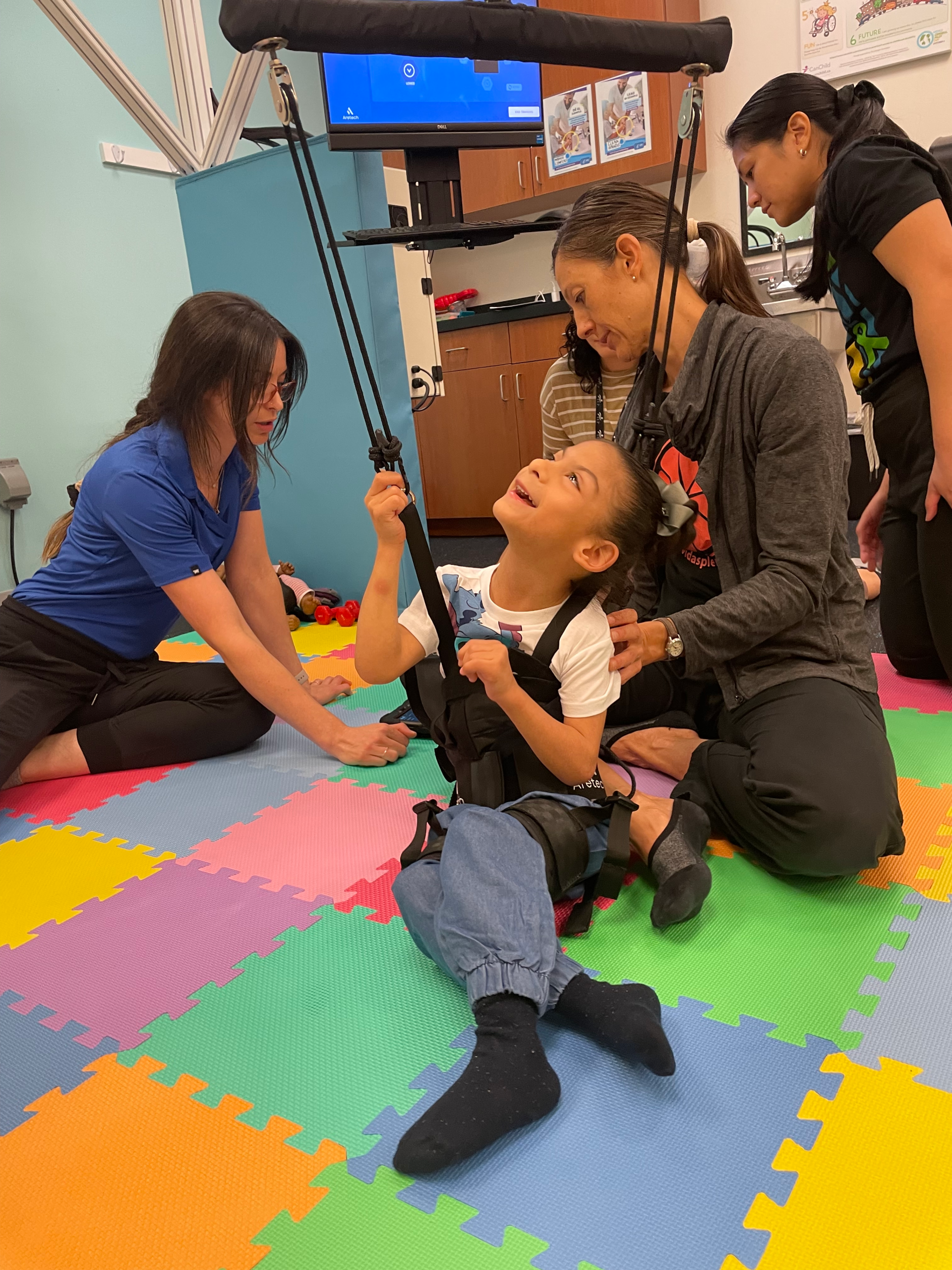 Infant in Baby G robotic harness during pediatric physical therapy at UCP of Central Arizona Downtown East Campus in Phoenix AZ