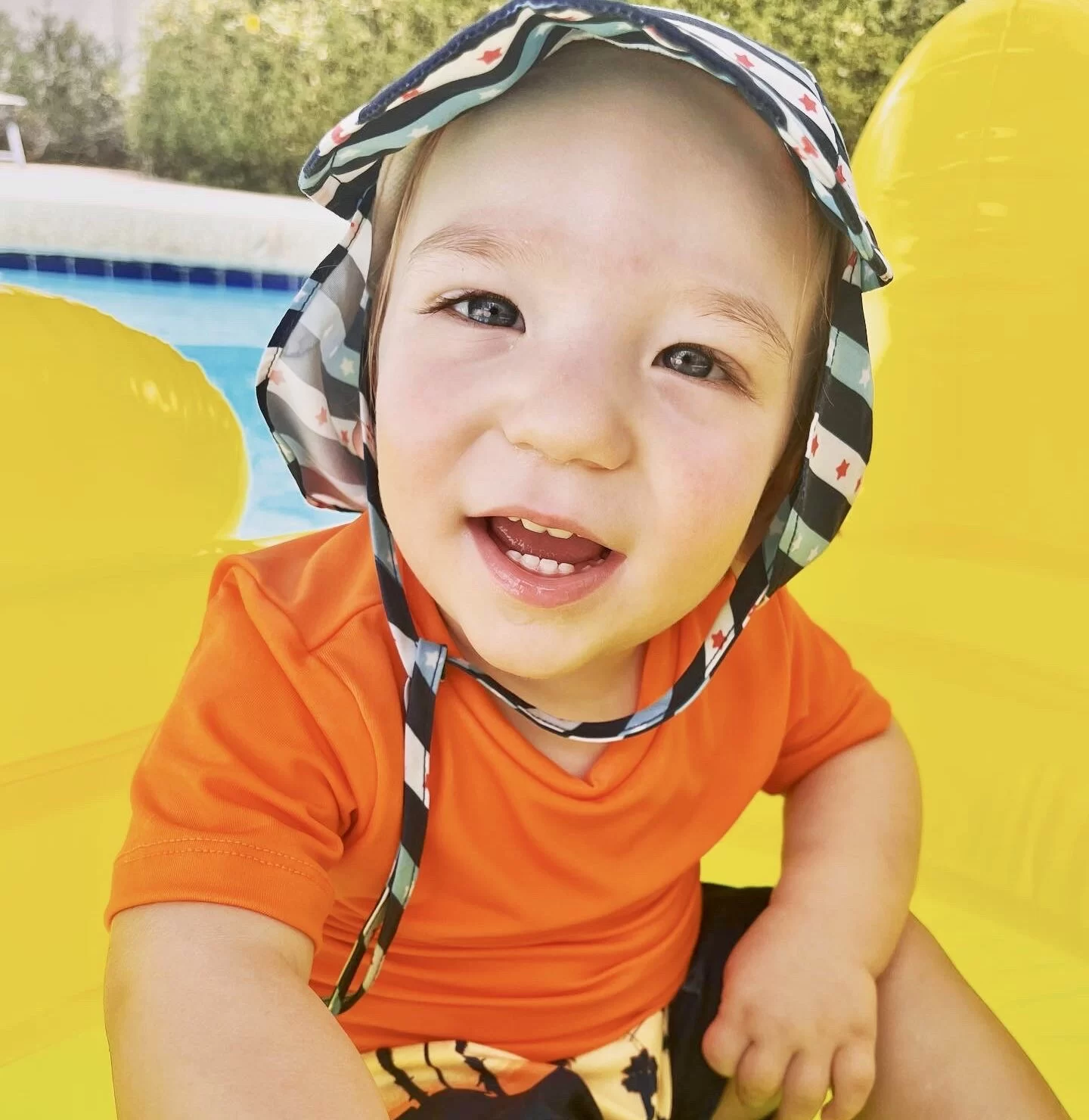 A baby with cerebral palsy wearing a hat in a pool at the pediatric therapy center. Jordan our ambassador for united cerebral palsy wearing a hat in a pool.