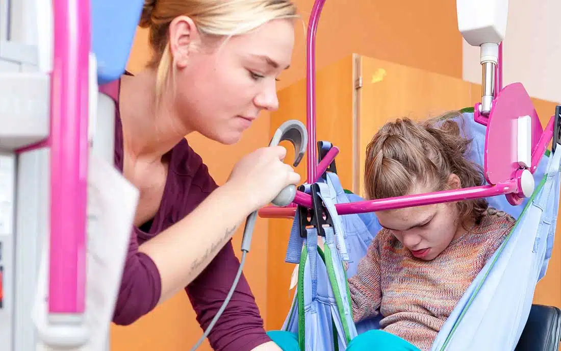 A young girl with cerebral palsy of Arizona is sitting in a chair with a stethoscope. A young girl with cerebral palsy of Arizona is sitting in a chair with a stethoscope.